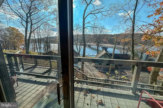 a living room with furniture a couch and large windows