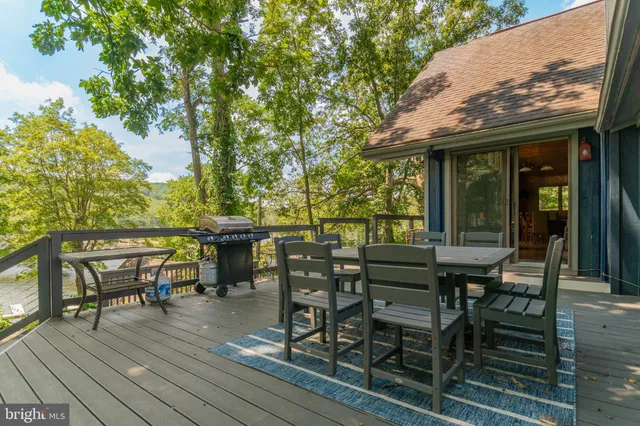 a front view of a house with a garden and trees