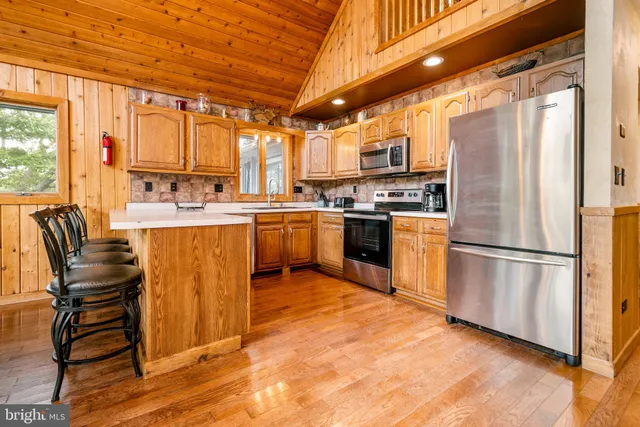 a living room with furniture a chandelier and a dining table
