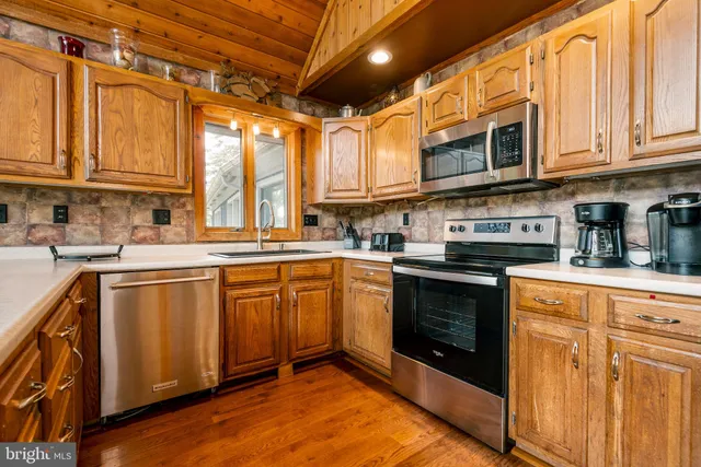 a living room with furniture a fireplace and a large window