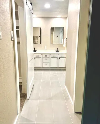 a bathroom with a double vanity sink mirror and