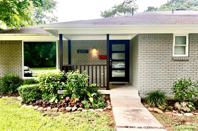 a front view of a house with a garden