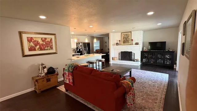 a living room with furniture fireplace and flat screen tv