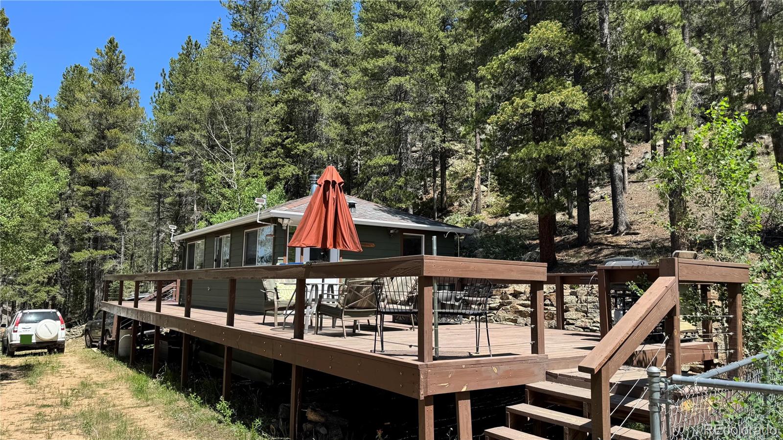 582 Pactolus Lake Road Black Hawk, CO 80422 - Photo 11 of 11 a balcony with wooden floor and outdoor seating