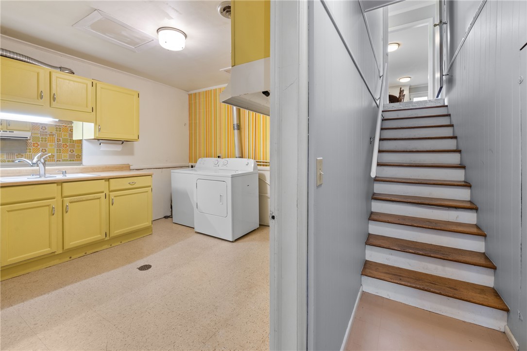 210 Riggs Drive Clemson, SC 29631 - Photo 18 of 36 This functional space combines a practical kitchen area with convenient laundry facilities and access to upper levels.