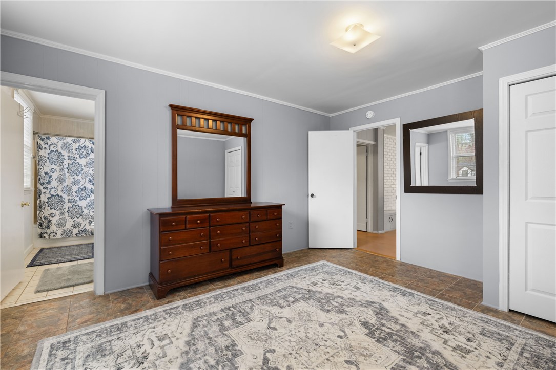 210 Riggs Drive Clemson, SC 29631 - Photo 20 of 36 This cozy bedroom features a neutral palette with tile flooring and bright natural light.