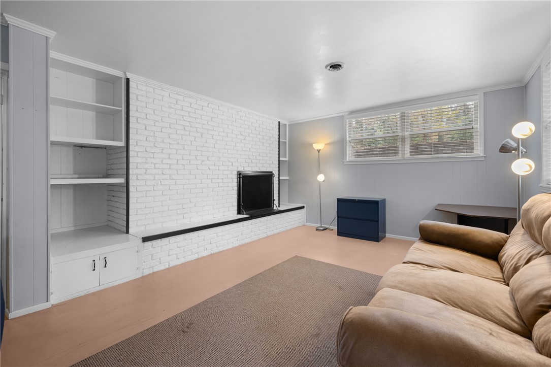 210 Riggs Drive Clemson, SC 29631 - Photo 22 of 36 This versatile room features a whitewashed brick fireplace, built-in shelving, and warm flooring.