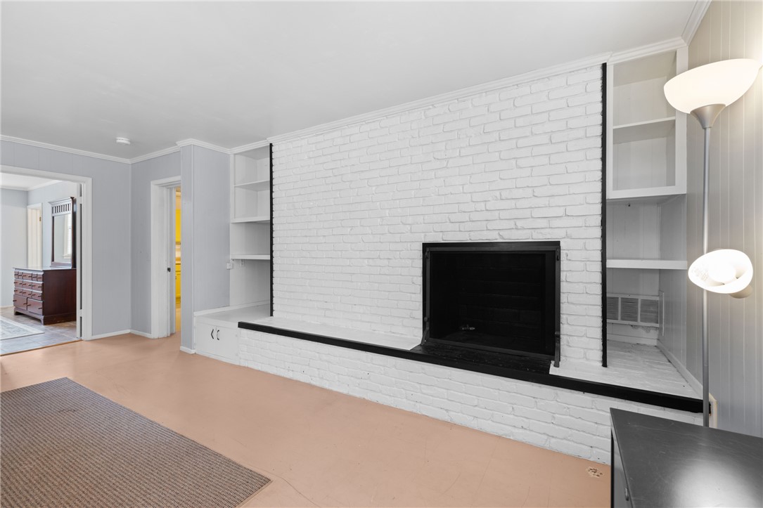210 Riggs Drive Clemson, SC 29631 - Photo 23 of 36 This inviting living space features a cozy fireplace and built-in shelving, offering both warmth and functional storage.