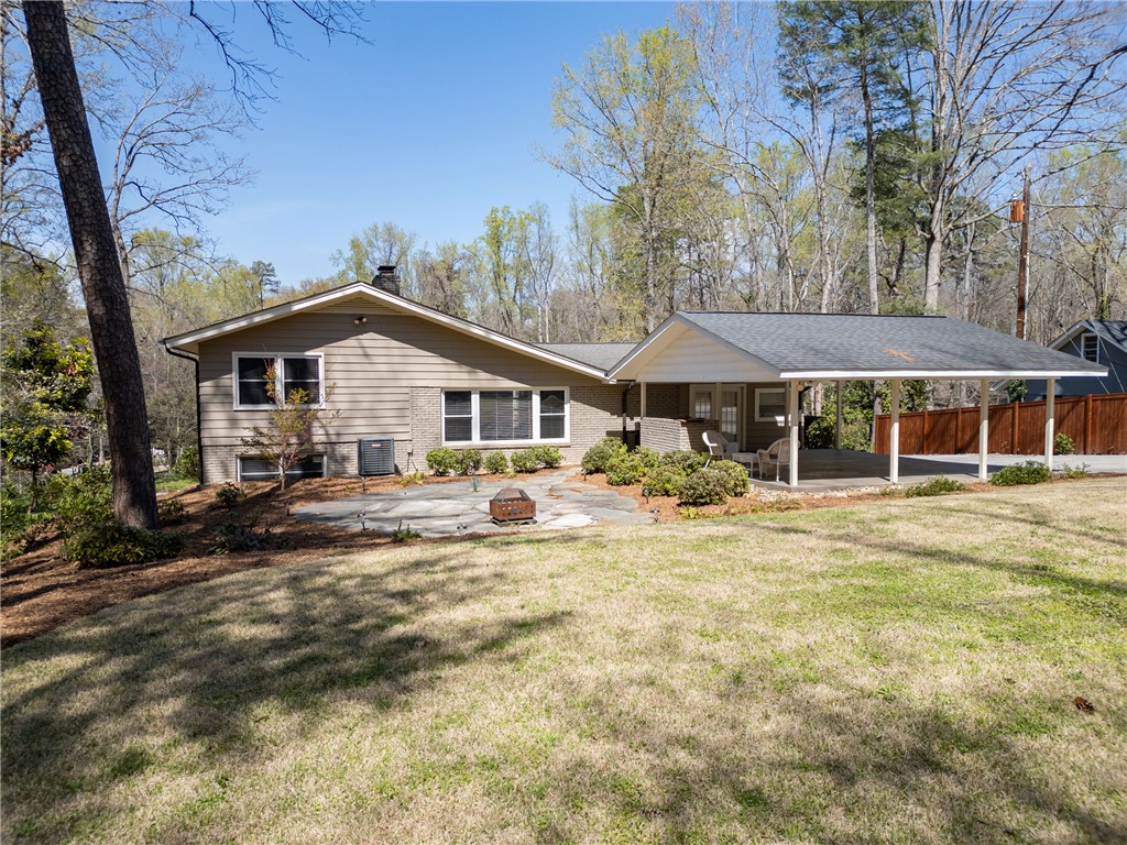 210 Riggs Drive Clemson, SC 29631 - Photo 26 of 36 This charming home offers a serene outdoor living space with a lush green yard.