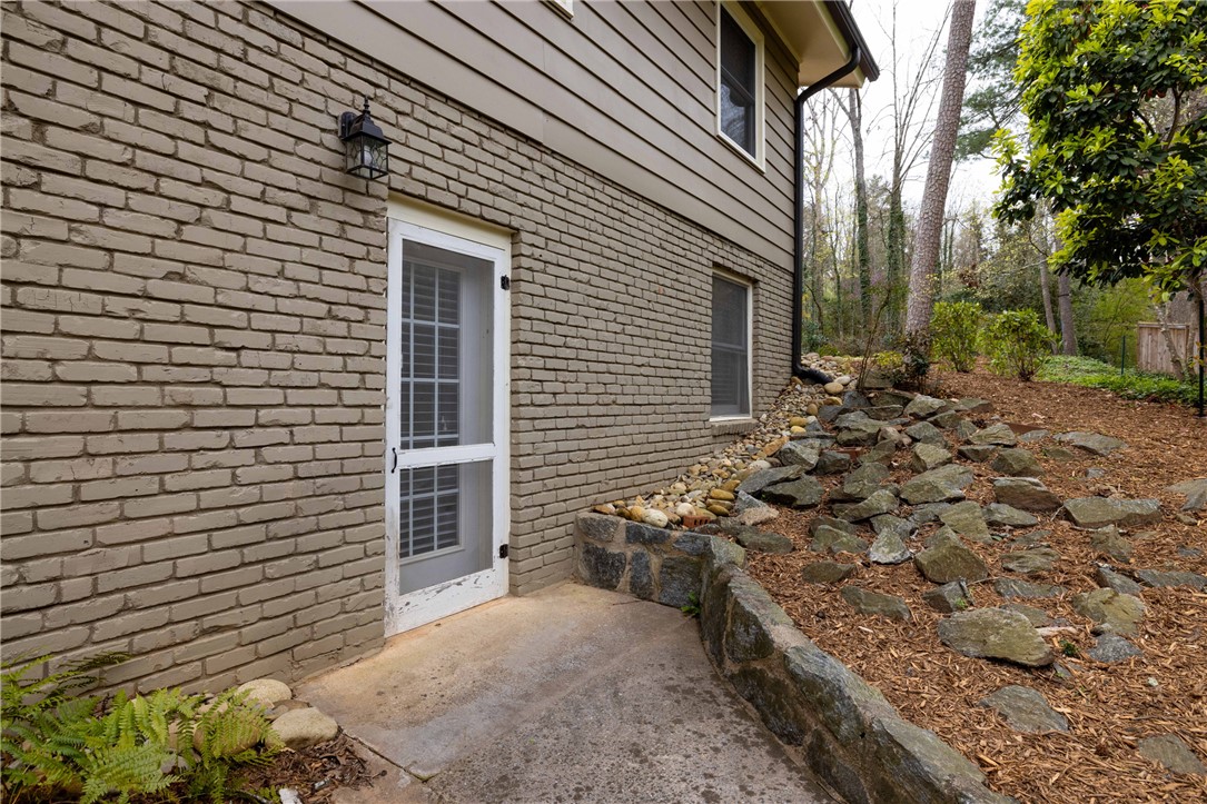 210 Riggs Drive Clemson, SC 29631 - Photo 36 of 36 This house features a charming brick exterior and an inviting patio with natural landscaping.