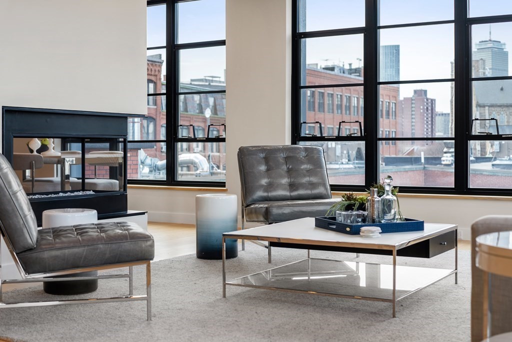 a living room with furniture and a floor to ceiling window