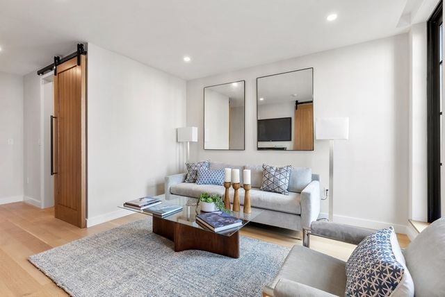 a living room with furniture and a rug