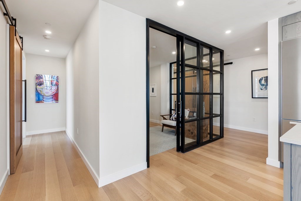 76 Wareham Street, Unit 4A Boston, MA 02118 - Photo 13 of 38 a view of a hallway with wooden floor and cabinet