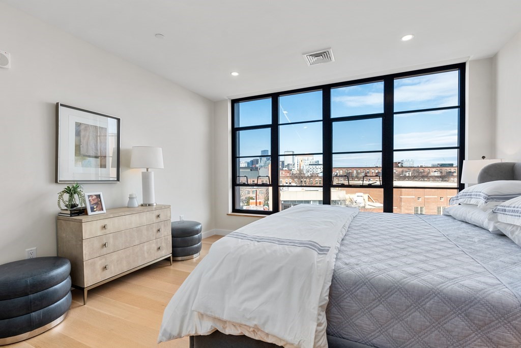 76 Wareham Street, Unit 4A Boston, MA 02118 - Photo 18 of 38 a spacious bedroom with a bed and a large window