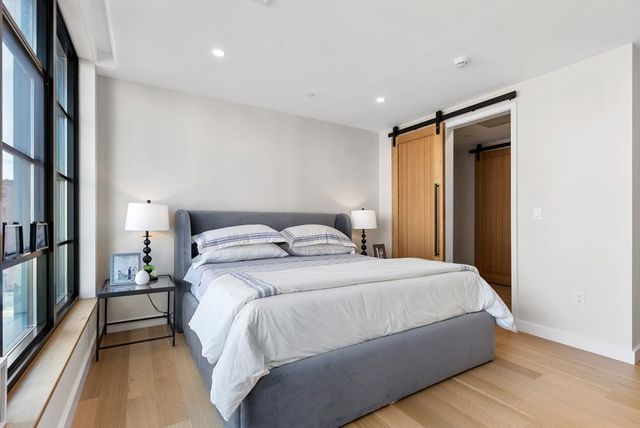 a bedroom with a bed and a large mirror