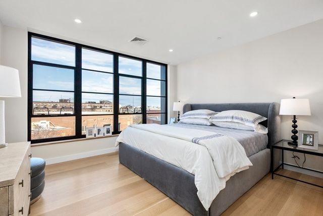 a spacious bedroom with a large bed and a large window