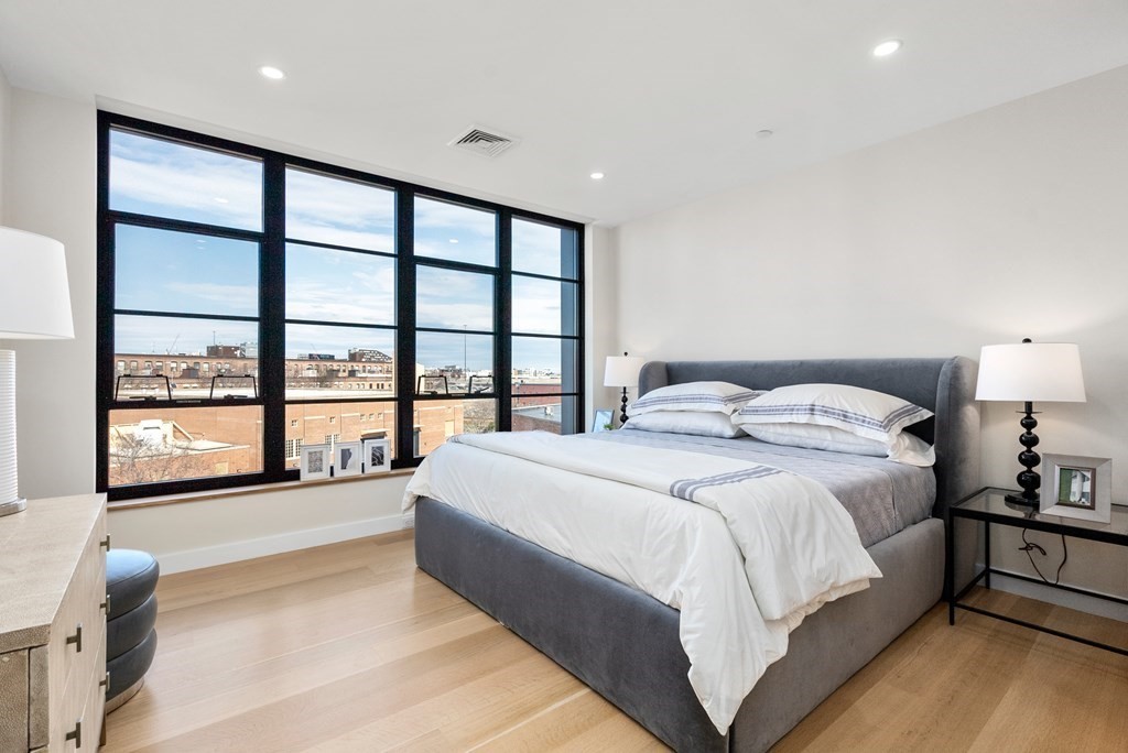 76 Wareham Street, Unit 4A Boston, MA 02118 - Photo 21 of 38 a spacious bedroom with a large bed and a large window