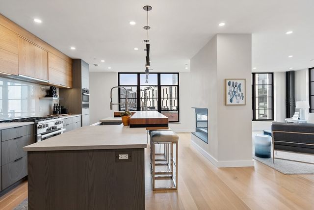 a kitchen with a sink appliances and a counter top space