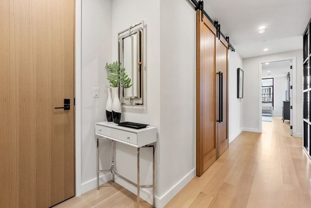 a view of a hallway and wooden floor and a living room