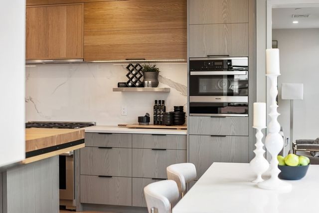 a kitchen with a sink cabinets and appliances