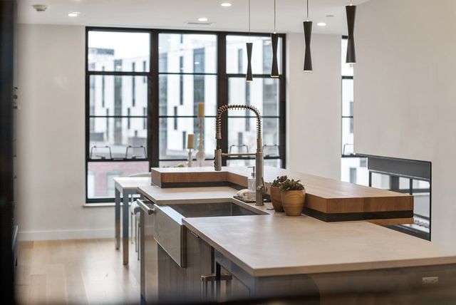 a kitchen with stainless steel appliances granite countertop a sink and a stove