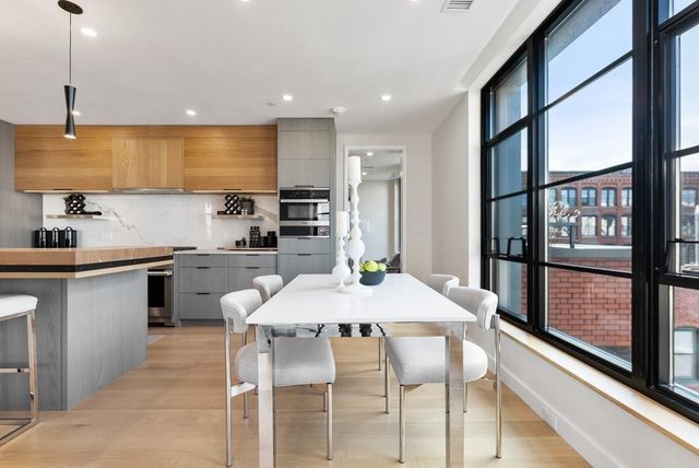 a kitchen with a table chairs sink and cabinets