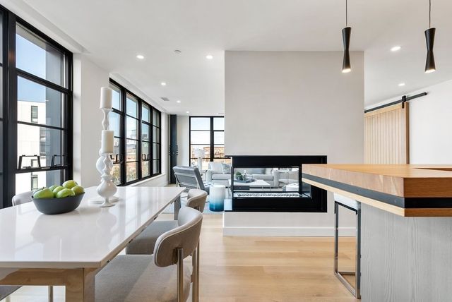 a kitchen with stainless steel appliances kitchen island granite countertop a refrigerator a sink and a stove