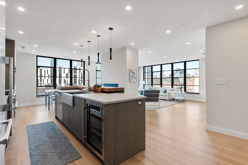 76 Wareham Street, Unit 4A Boston, MA 02118 - Photo 10 of 38 a large kitchen with stainless steel appliances granite countertop a large center island and a sink