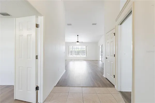 a view of an empty room with a kitchen