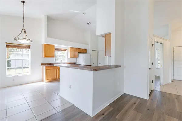 a kitchen with stainless steel appliances granite countertop a refrigerator and a stove top oven