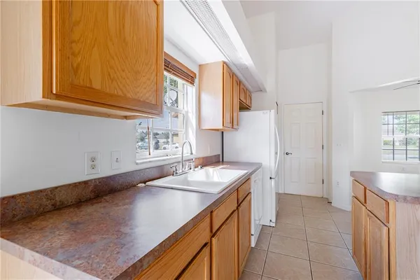 a kitchen with stainless steel appliances granite countertop a sink counter space cabinets and a window