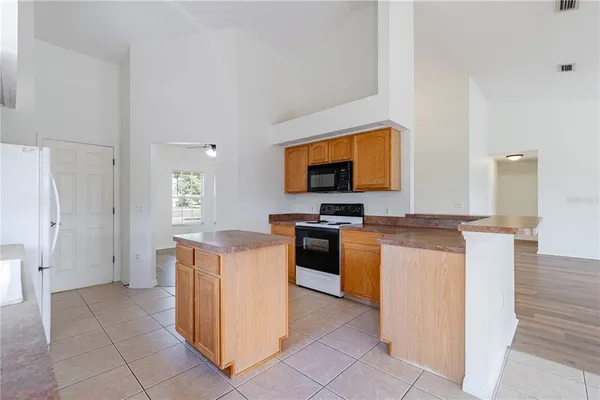 a kitchen with a sink a stove and cabinets
