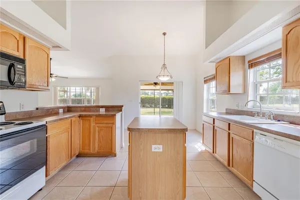 a kitchen with a stove a sink and a refrigerator