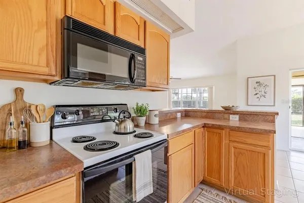 a kitchen with sink cabinets and wooden floor