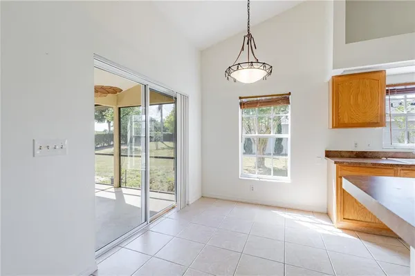 a view of an empty room with a window and a ceiling fan