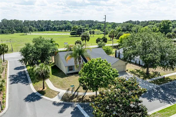 an aerial view of a house with a yard and garden