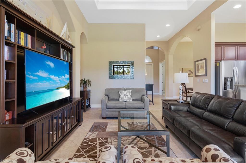 7794 Ashton Road Naples, FL 34113 - Photo 11 of 34 a living room with furniture and a flat screen tv