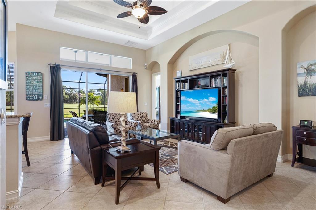 7794 Ashton Road Naples, FL 34113 - Photo 12 of 34 a living room with furniture a large window and a flat screen tv