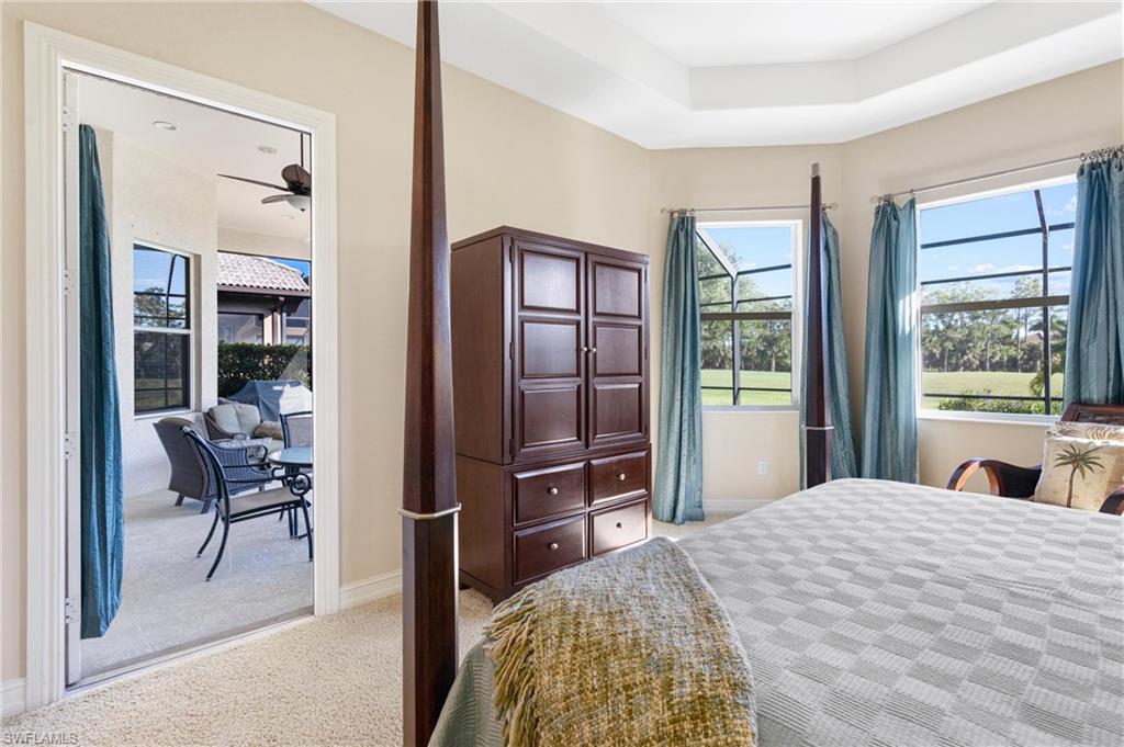 7794 Ashton Road Naples, FL 34113 - Photo 15 of 34 a bedroom with a bed and a dresser next to a window