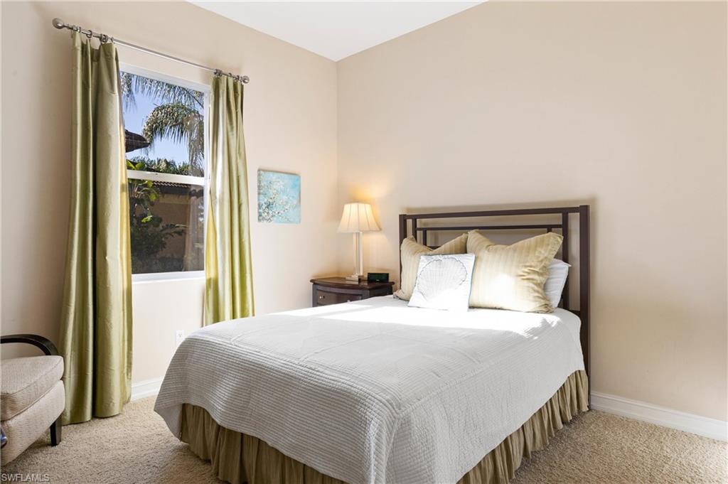 7794 Ashton Road Naples, FL 34113 - Photo 19 of 34 a bedroom with a bed and a painting on the wall