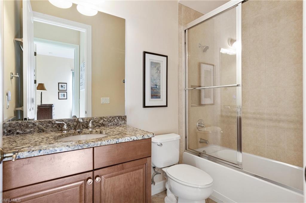 7794 Ashton Road Naples, FL 34113 - Photo 20 of 34 a bathroom with a granite countertop sink toilet and shower