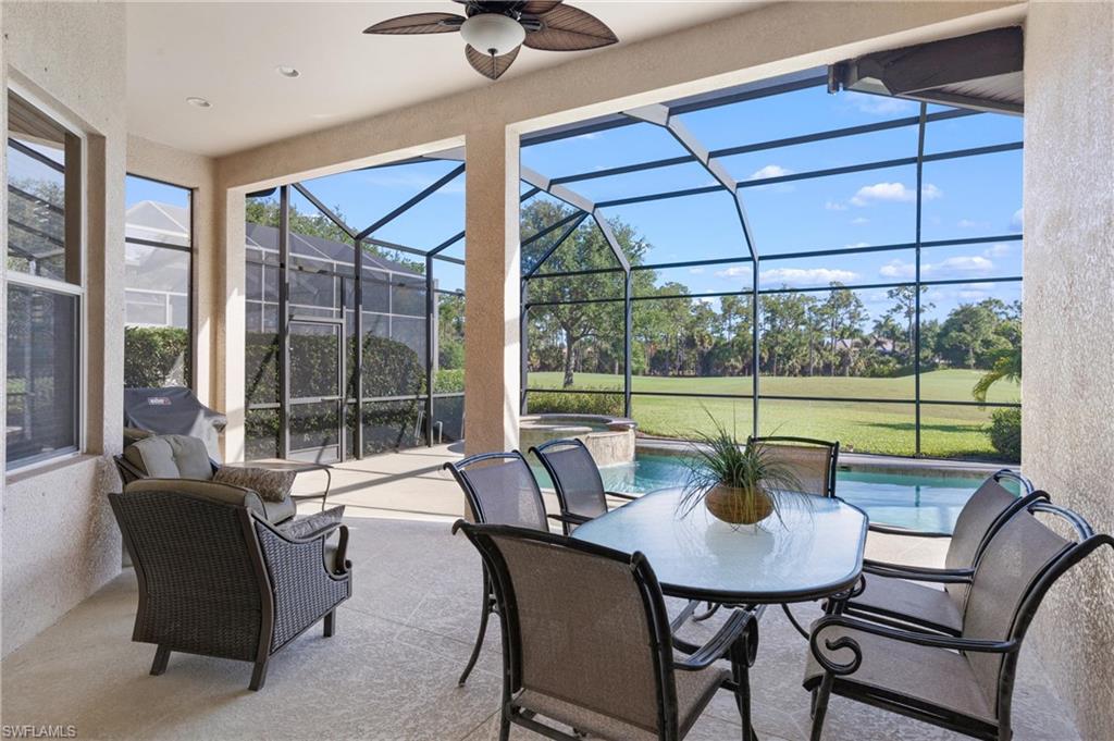 7794 Ashton Road Naples, FL 34113 - Photo 22 of 34 a view of a living room and balcony with table and chairs