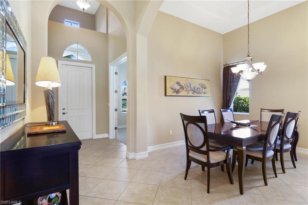 7794 Ashton Road Naples, FL 34113 - Photo 3 of 34 a dining room with furniture and chandelier