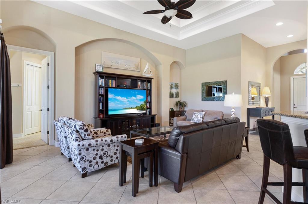 7794 Ashton Road Naples, FL 34113 - Photo 10 of 34 a living room with furniture and a flat screen tv