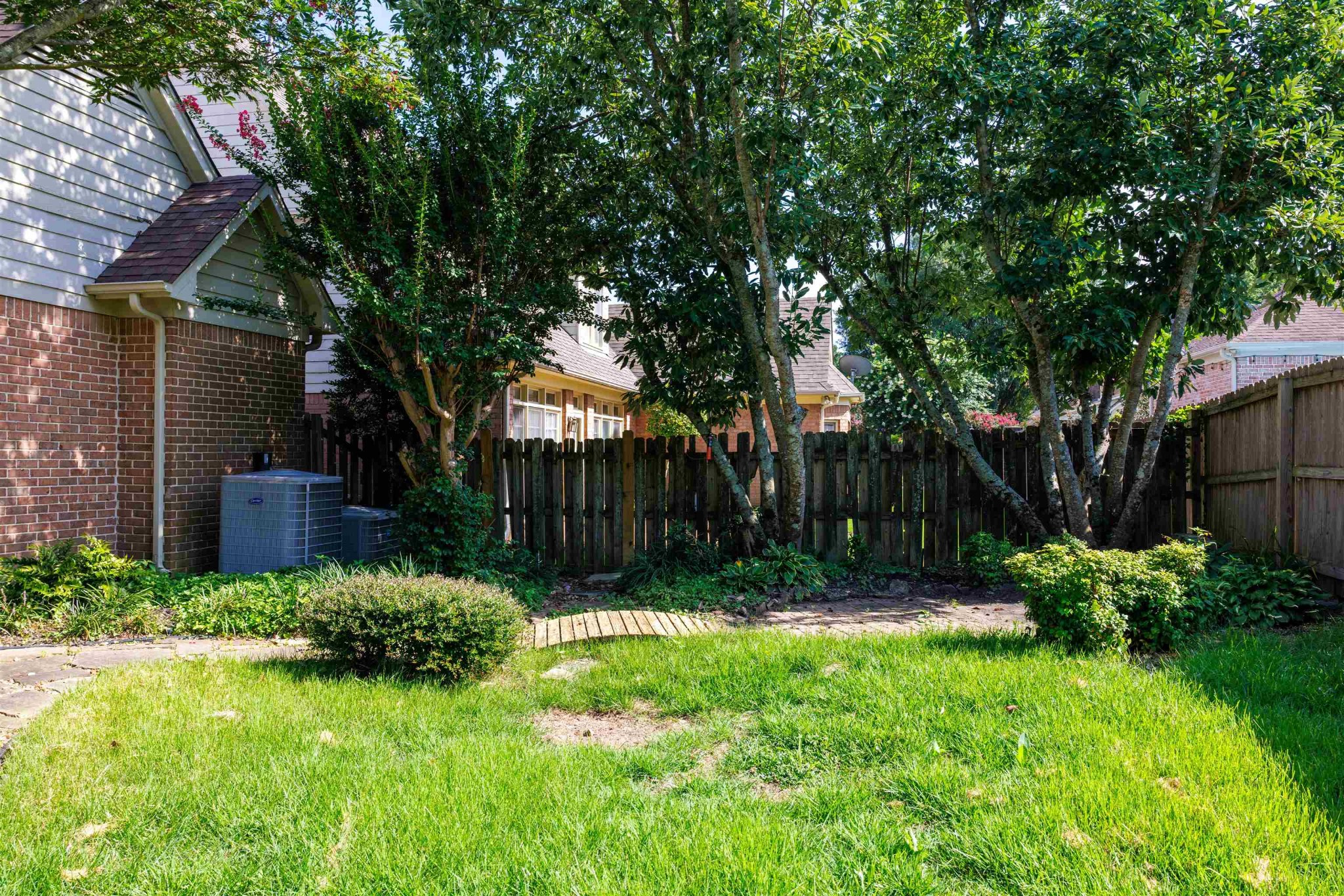 95 Morris Manor Drive Collierville, TN 38017 - Photo 33 of 35 a view of backyard with large trees and plants