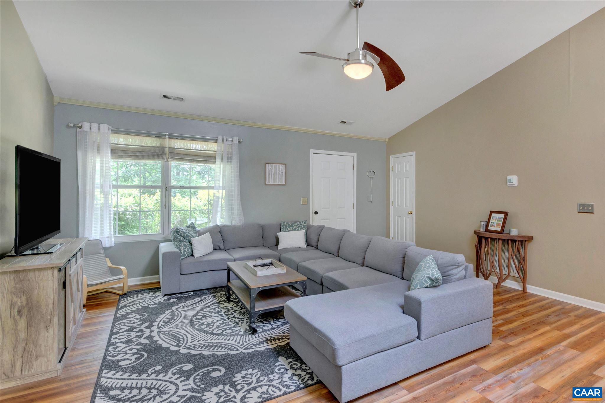 352 East Daffodil Road Ruckersville, VA 22968 - Photo 7 of 36 a living room with furniture a flat screen tv and a window