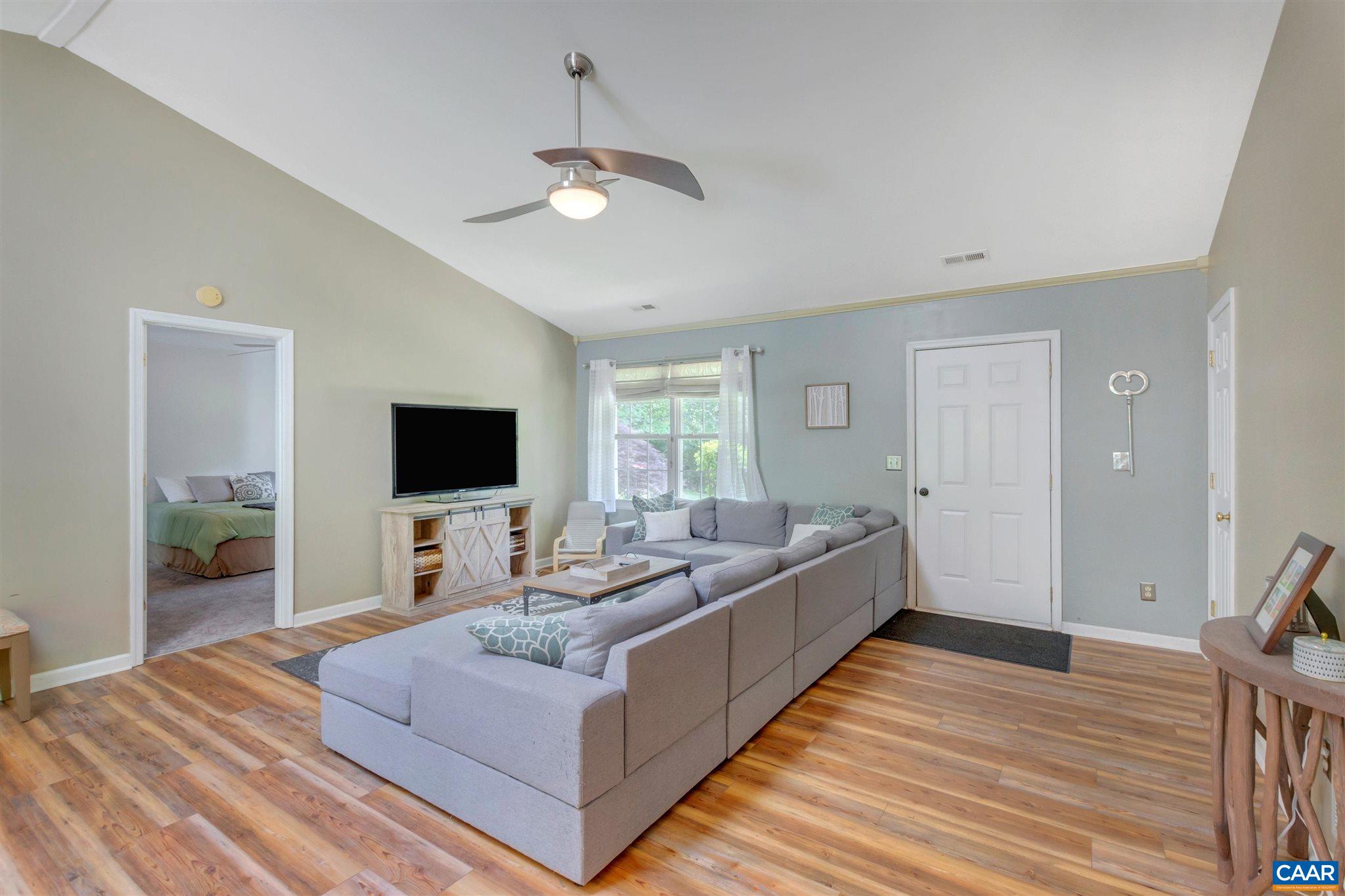 352 East Daffodil Road Ruckersville, VA 22968 - Photo 8 of 36 a living room with furniture and a flat screen tv