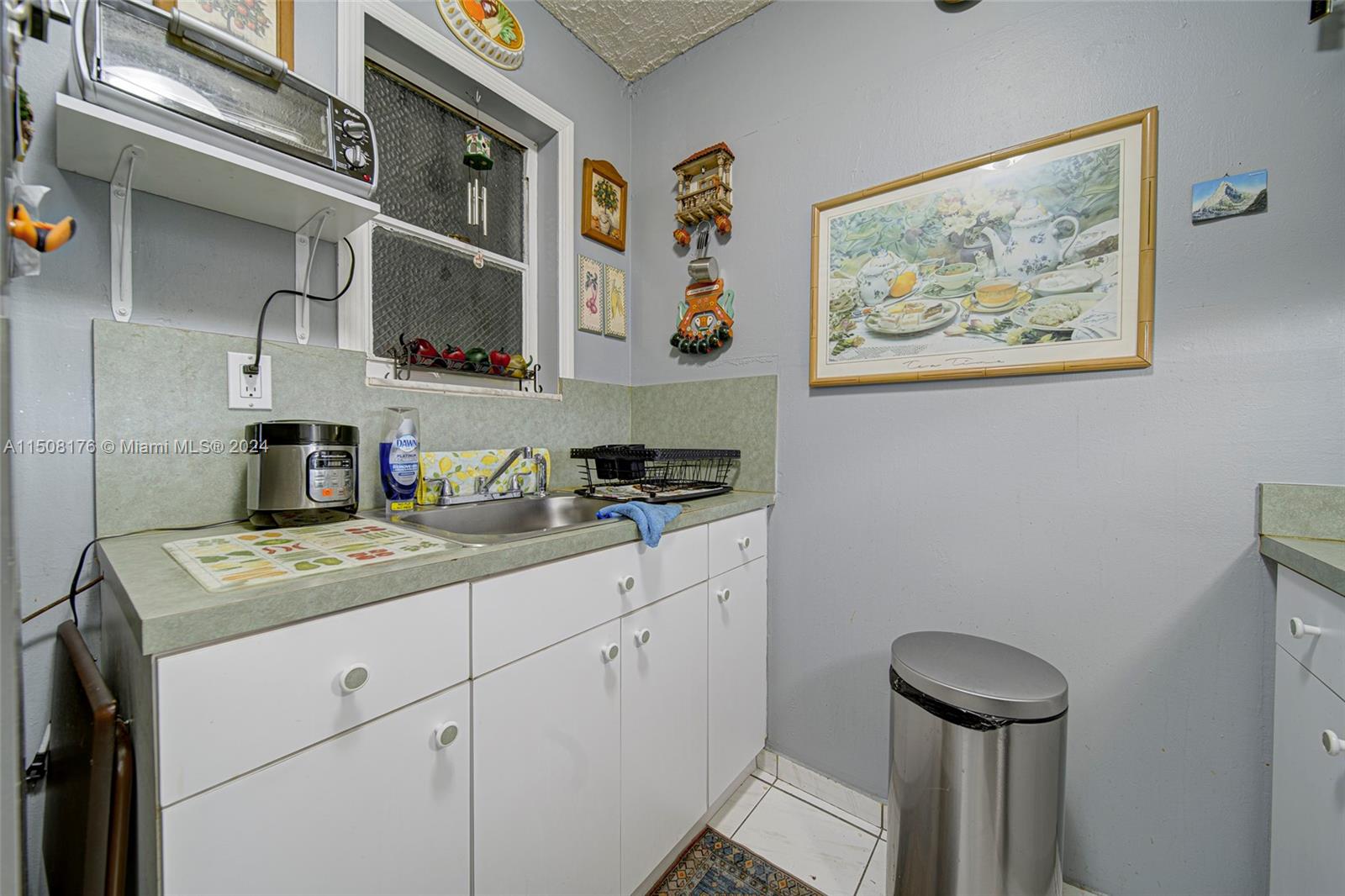 Coral Gate Miami, FL 33145 - Photo 25 of 35 a kitchen with a sink a stove and cabinets