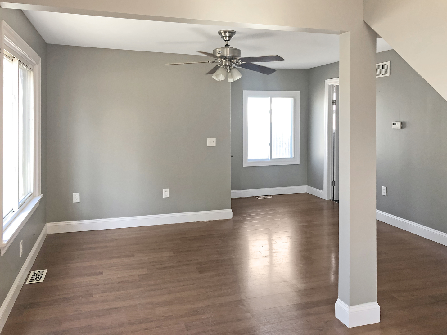 Undisclosed Address Round Lake Beach, IL 60073 - Photo 3 of 8 a view of a livingroom with wooden floor and a ceiling fan