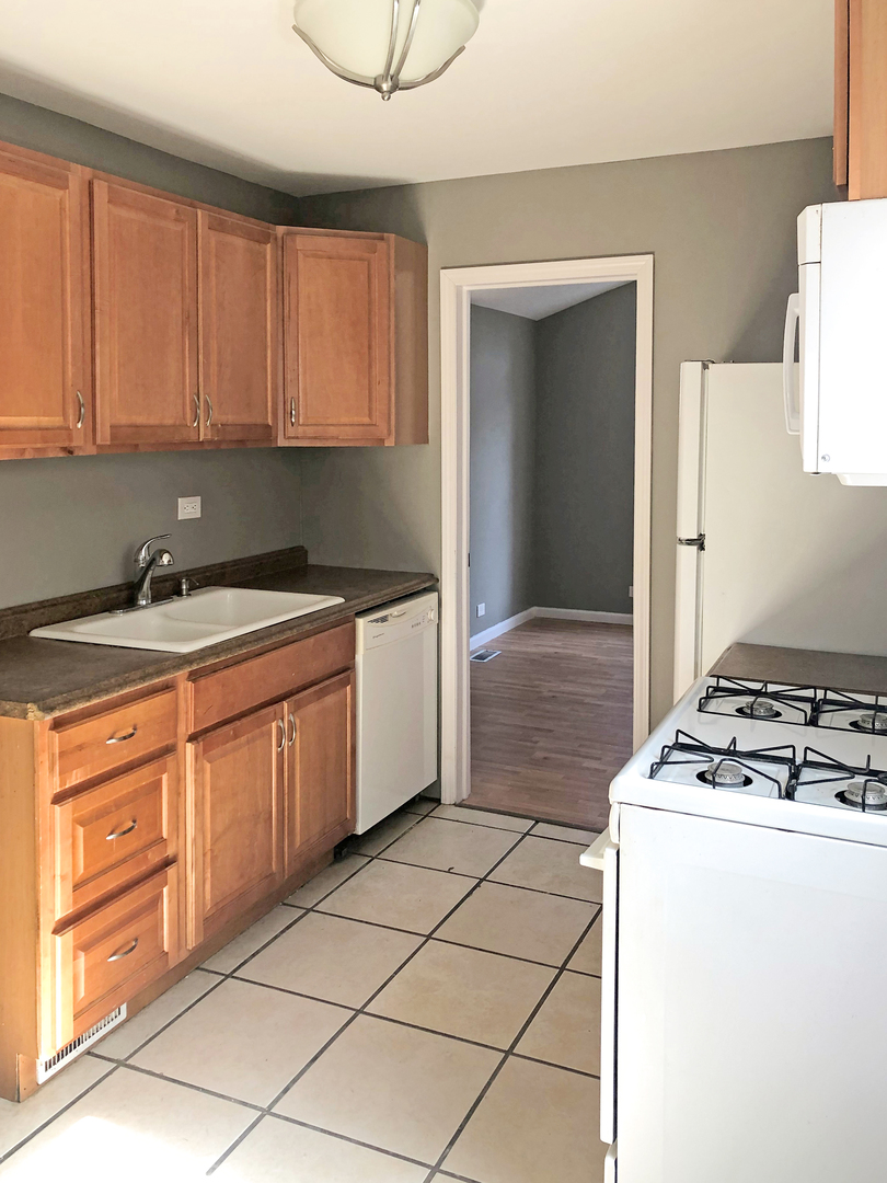 Undisclosed Address Round Lake Beach, IL 60073 - Photo 4 of 8 a kitchen with a sink a stove and cabinets